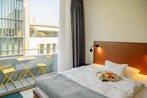Giường trong phòng chung tại Nomad Design & Lifestyle Hotel