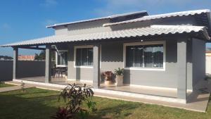 a rendering of a small house with a porch at Vila Sunset Saquarema RJ in Saquarema