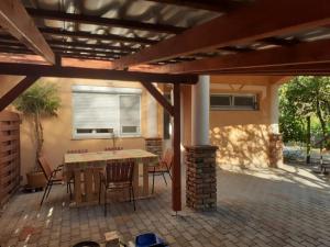 a patio with a table and chairs under a pergola at Ibolya in Balatonfüred