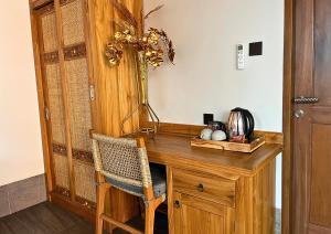 a wooden desk with a chair in a room at Maharatu Suite Villa in Ubud