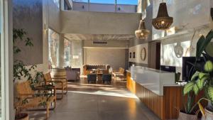 a living room with a table and chairs at Gran Hotel Dakar in Mendoza