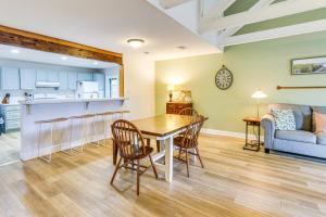 a kitchen and living room with a table and chairs at Pool Access and Pet Friendly Condo in Hilton Head in Hilton Head Island