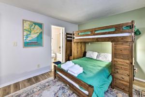 a bedroom with a bunk bed with green sheets at Pool Access and Pet Friendly Condo in Hilton Head in Hilton Head Island
