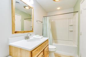 a bathroom with a sink and a toilet and a mirror at Pool Access and Pet Friendly Condo in Hilton Head in Hilton Head Island +16 photos