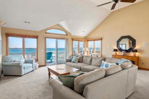 a living room with a couch and a table at The Gathering Place in Duck