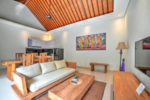 a living room with a couch and a table at Villa LAKSMI in Seminyak