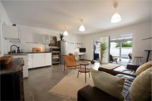 a living room with a couch and a table at "Sun down" by Corralejobeach Apartments in Corralejo +19 photos