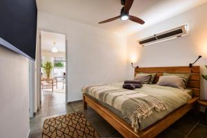 a bedroom with a bed and a ceiling fan at "Sun down" by Corralejobeach Apartments in Corralejo