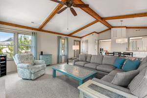 a living room with a couch and a table at The Mayors Nest in Duck +32 photos