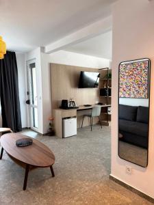a living room with a black couch and a table at Hotel Mistral in Nesebar