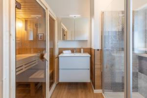 a small bathroom with a sink and a shower at Huus Blaumees in Kating +15 photos