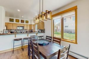 a kitchen and dining room with a table and chairs at Moose Crossing at Town Center in Big Sky