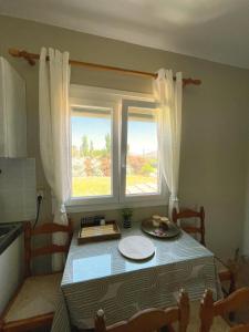 a table in a kitchen with a window at New Poseidon Apartments & Studios in Skala Eresou +17 photos