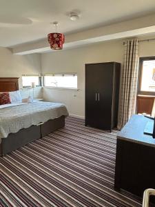 a bedroom with a bed and a dresser in it at 11 The Avenue in Killarney