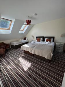 a bedroom with a bed and a couch and windows at 11 The Avenue in Killarney