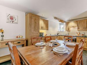 Una gran cocina con una mesa y sillas de madera. en 2 Bed in Launceston 92552, en Saint Giles on the Heath 12 fotos más