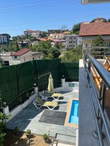 a patio with two chairs and a swimming pool at White House in Sapanca