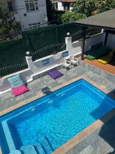 a swimming pool with purple cushions and a table at White House in Sapanca