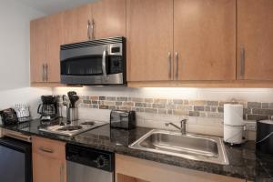 a kitchen with a sink and a microwave at Fraser Crossing 3518 Studio in Winter Park