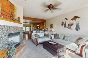 a living room with a couch and a fireplace at View House in Fraser