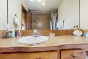 a bathroom with a sink and a mirror at View House in Fraser +14 photos