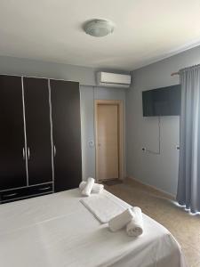 a bedroom with a bed with two towels on it at Anna House Dhermi in Dhërmi