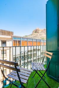 a bench sitting on top of a balcony at White Coast Suites in Alicante