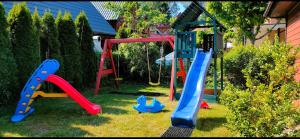 a yard with a playground with a swing at Letnisko Laba in Pobierowo