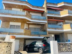 a small car parked in front of a building at Costa Brava - Roses - Terrace & sea view in Roses