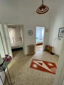 a room with a bedroom with a bed and a rug at Beach House in Nea Peramos in Nea Peramos