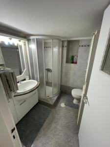 a bathroom with a sink and a toilet and a shower at Beach House in Nea Peramos in Nea Peramos +13 photos