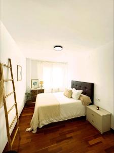 a bedroom with a bed with a ladder and a window at EnBURELA Sol y Playa in Burela de Cabo