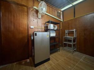 a kitchen with a refrigerator and a fan at Lamai home 4 in Ko Yao Noi