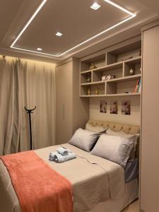 a bedroom with a bed with towels on it at Apartamento Residencial Serigy in Aracaju