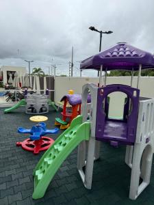 a playground with a slide and other play equipment at Apartamento Residencial Serigy in Aracaju