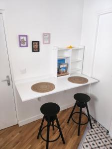 a white desk with two stools in a room at Sun Studio - 2 people - City Center in Charleville-Mézières +7 photos