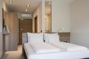Posteľ alebo postele v izbe v ubytovaní Boutiquehotel Minigolf
