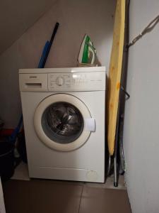 a white washing machine in a room with tools at Apartment in Heart of Užupis - perfect location in Vilnius