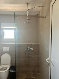 a bathroom with a toilet and a glass shower at Maki Apartmani in Ulcinj +71 photos