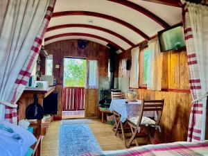 a room with a table and a dining room at hillgate farm lodges in Godney Hill