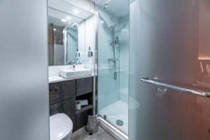 a bathroom with a shower and a toilet and a sink at easyHotel Leeds in Leeds