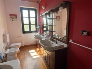a bathroom with three sinks and two toilets at Charming Italian Home sleeps 6 Cantarana in Cantarana +96 photos