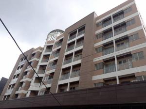 a tall building with a clock on top of it at Julias Cozy Mountain Condo Couples Getaway in Baguio +12 photos