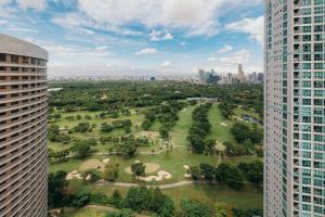 an aerial view of a park between two buildings at Modern Coastal Design 1 BR Condo Golf View BGC in Manila