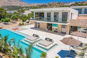 an aerial view of a villa with a swimming pool at Villa Pefkos Shore by Villa Plus in Pefki Rhodes