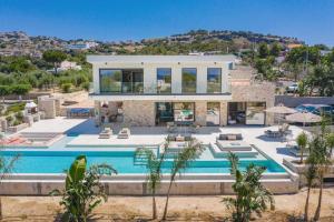 a villa with a swimming pool in the desert at Villa Pefkos Cove by Villa Plus in Pefki Rhodes