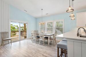 a kitchen and dining room with a table and chairs at Tranquility Cove in Nags Head