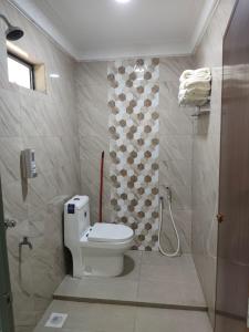 a bathroom with a toilet and a shower at Homestay Baitulmakarem in Banting