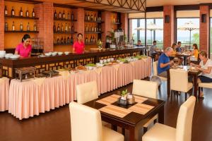 a restaurant with a bar with people sitting at tables at Yen Indochine in Nha Trang