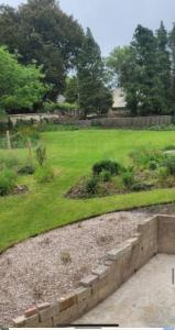 a landscaped yard with a field of green grass at Broadwindsor Cottage in Broadwindsor +14 photos
